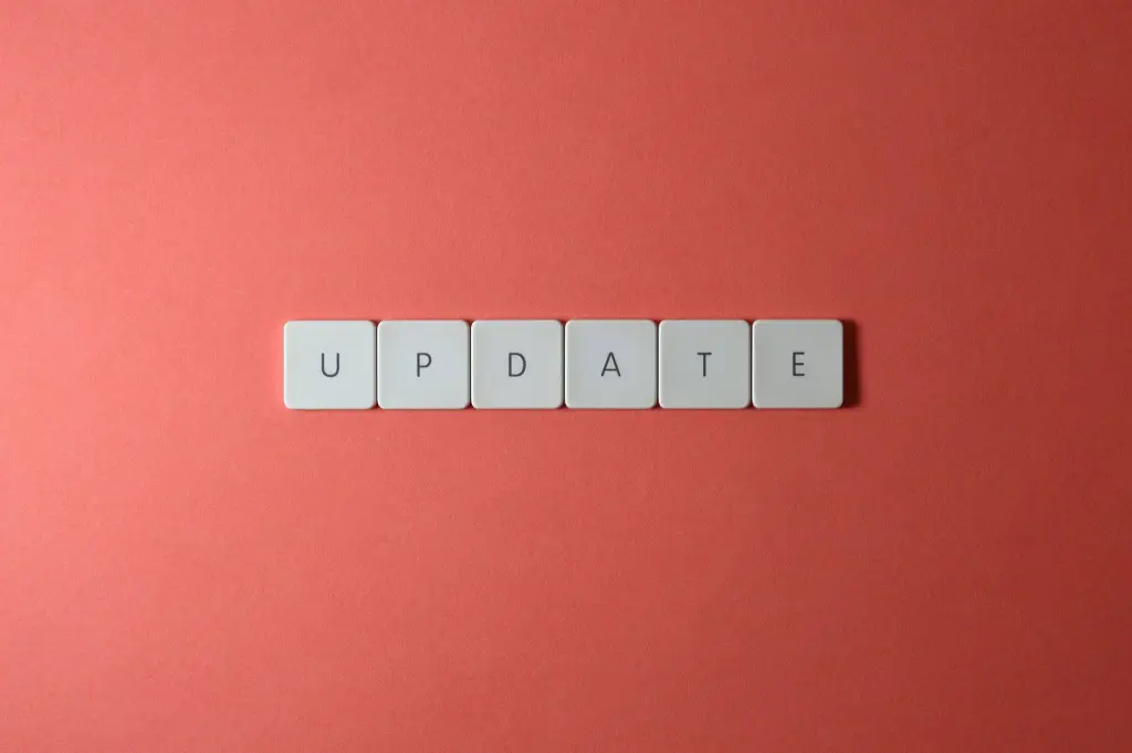 Keyboard keys arranged to spell 'update' on a vibrant red background, ideal for conveying tech concepts.
