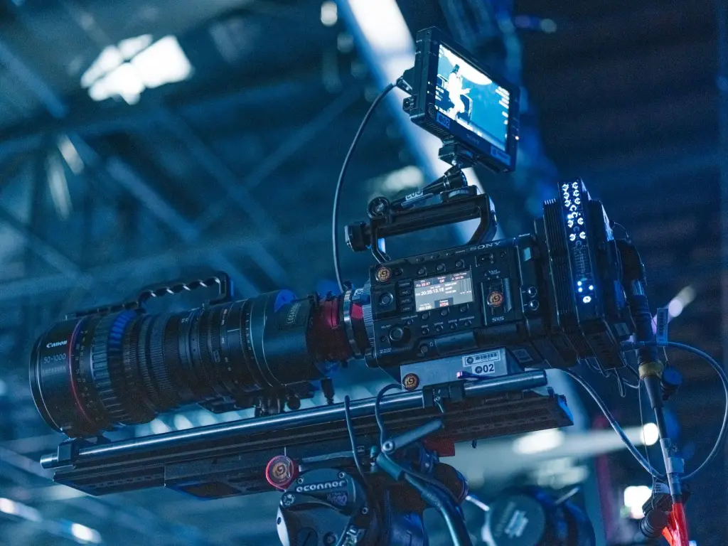 Close-up of a high-end video camera setup in a professional studio setting ready for filming.
