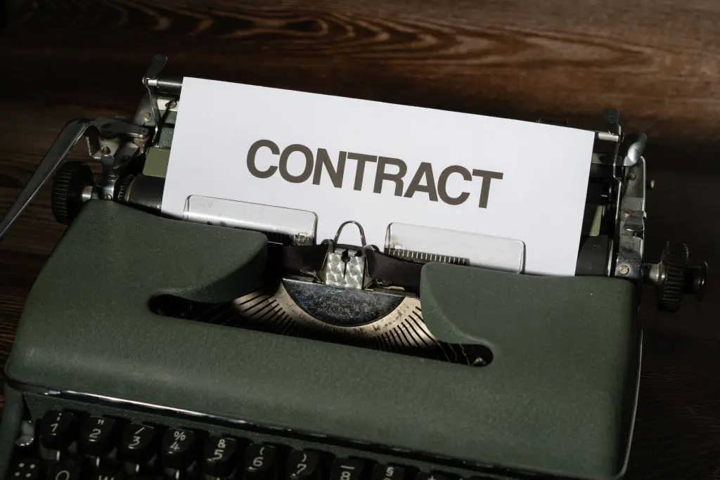 Close-up of a vintage typewriter with a paper labeled 'Contract', evoking a retro office theme.