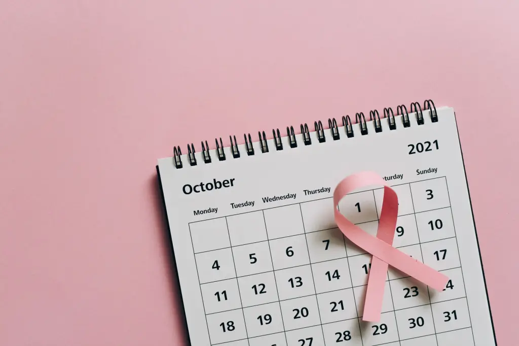 Pink ribbon on October calendar symbolizes breast cancer awareness.