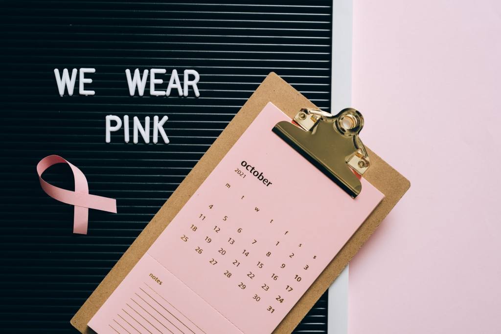 Pink October calendar with ribbon for breast cancer awareness advocacy.